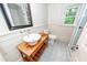 Charming bathroom with a vessel sink on a rustic vanity and shiplap walls at 3166 Edenvale Rd, Johns Island, SC 29455