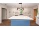 Bright kitchen featuring a blue island, white cabinets, and modern lighting at 3166 Edenvale Rd, Johns Island, SC 29455