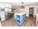 Modern kitchen with white cabinets, stainless steel appliances, and a blue island at 3166 Edenvale Rd, Johns Island, SC 29455