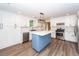 Bright kitchen features white cabinets, stainless steel appliances, blue island with white countertop, and modern lighting at 3166 Edenvale Rd, Johns Island, SC 29455