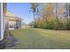 A spacious backyard with a well-maintained lawn and screened porch, perfect for outdoor activities and relaxation at 3215 Safe Harbor Way, Charleston, SC 29414