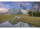Backyard featuring a water feature and view of the home's screened in porch at 3215 Safe Harbor Way, Charleston, SC 29414