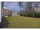 Spacious backyard with a screened-in porch, perfect for outdoor entertaining and relaxation at 3215 Safe Harbor Way, Charleston, SC 29414