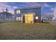 Back exterior view featuring a screened-in porch, solar panels and a well-maintained lawn at 3215 Safe Harbor Way, Charleston, SC 29414
