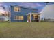 Back exterior view featuring a screened-in porch, solar panels and a well-maintained lawn at 3215 Safe Harbor Way, Charleston, SC 29414