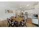 Light-filled dining room showcasing wood table and sightlines to the kitchen at 3215 Safe Harbor Way, Charleston, SC 29414