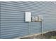 Exterior with Tesla solar panel components featuring electric and power meter boxes on a house's grey siding at 3215 Safe Harbor Way, Charleston, SC 29414