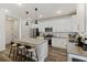 Spacious kitchen with a large island, modern lighting, and stainless steel appliances at 3215 Safe Harbor Way, Charleston, SC 29414