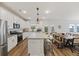 Modern kitchen featuring an island with barstool seating, stainless appliances and backyard access at 3215 Safe Harbor Way, Charleston, SC 29414