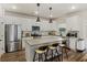 Bright kitchen with white cabinets, stainless steel appliances, a gray quartz countertop, and a stylish breakfast bar at 3215 Safe Harbor Way, Charleston, SC 29414