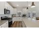 Well-lit kitchen featuring gray countertops, stainless steel appliances, and modern fixtures at 3215 Safe Harbor Way, Charleston, SC 29414