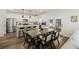 Open-concept kitchen with white cabinets and a spacious dining area featuring a rustic wood table at 3215 Safe Harbor Way, Charleston, SC 29414
