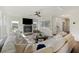 Bright and airy living room with a large sectional, fireplace, wood floors, and contemporary decor at 3215 Safe Harbor Way, Charleston, SC 29414