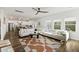 Bright, open-concept living room featuring a large sectional sofa and modern ceiling fan at 3215 Safe Harbor Way, Charleston, SC 29414