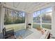 Cozy screened porch with comfortable seating, string lights, and view of backyard, perfect for relaxation and entertaining at 3215 Safe Harbor Way, Charleston, SC 29414