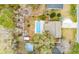 Aerial view of a home showcasing a pool, shed, patio, privacy fence, and mature trees at 3308 Island Estates Dr, Johns Island, SC 29455