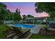 Backyard pool featuring an inviting screened-in porch and two cushioned lounge chairs at 3308 Island Estates Dr, Johns Island, SC 29455