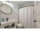 Clean bathroom with white subway tiles, a sleek vanity, a round mirror, and a shower with curtain at 3308 Island Estates Dr, Johns Island, SC 29455
