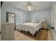 Comfortable bedroom with light blue walls, neutral rug, ceiling fan, and plenty of natural light at 3308 Island Estates Dr, Johns Island, SC 29455