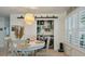 Cozy dining area with a round table, woven pendant light, and convenient access to laundry at 3308 Island Estates Dr, Johns Island, SC 29455