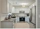Modern kitchen with stainless steel appliances, granite countertops, and bright white cabinetry at 3308 Island Estates Dr, Johns Island, SC 29455