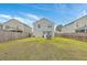 Spacious backyard featuring a grassy lawn, wooden fence, and a stone fire pit at 343 Iveson Rd, Summerville, SC 29486