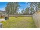 Fenced backyard with green grass, wooden fence, patio area, and a grill at 343 Iveson Rd, Summerville, SC 29486