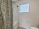 Clean bathroom bathtub with a shower curtain, toilet and large window at 343 Iveson Rd, Summerville, SC 29486