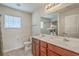 Bright bathroom featuring a double sink vanity with wood cabinets and a large mirror at 343 Iveson Rd, Summerville, SC 29486