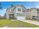 Inviting two-story home with a two-car garage, complemented by lush greenery and a manicured lawn at 343 Iveson Rd, Summerville, SC 29486