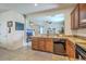 Open kitchen area features wooden cabinets, modern appliances, light countertops, and a view of the living room at 343 Iveson Rd, Summerville, SC 29486