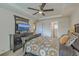 Large primary bedroom includes ceiling fan, dark furniture, a TV, and an en suite bathroom entrance at 343 Iveson Rd, Summerville, SC 29486