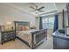 Spacious bedroom with tray ceiling, ceiling fan, dark furniture, and a large window with blue drapes at 343 Iveson Rd, Summerville, SC 29486