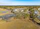 Stunning aerial view of a coastal neighborhood with marshland, beautiful houses, and private docks at 3894 Sawyers Island Dr, Mount Pleasant, SC 29466