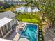 Aerial view of backyard with pool, putting green, lake, and lush landscaping at 3894 Sawyers Island Dr, Mount Pleasant, SC 29466
