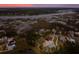 An aerial view of houses near a river and marshland with a pink sunset at 3894 Sawyers Island Dr, Mount Pleasant, SC 29466