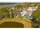 Aerial view of a beautiful home with a pool, play area, and pond, surrounded by lush greenery and neighborhood charm at 3894 Sawyers Island Dr, Mount Pleasant, SC 29466