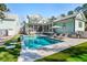 Spacious backyard featuring a sparkling pool, lush green lawn, and comfortable lounge area, ideal for leisure at 3894 Sawyers Island Dr, Mount Pleasant, SC 29466