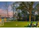 Spacious backyard featuring manicured lawn, mini-golf area and lake views at 3894 Sawyers Island Dr, Mount Pleasant, SC 29466