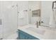 Modern bathroom with marble counters, stylish blue vanity, and glass-enclosed shower with white tile surround at 3894 Sawyers Island Dr, Mount Pleasant, SC 29466