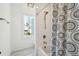 Bright bathroom with a window, bathtub and shower combination, and stylish blue and white patterned curtain at 3894 Sawyers Island Dr, Mount Pleasant, SC 29466