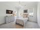 Cozy bedroom featuring a twin bed, grey dresser and sun-filled windows, creating a serene and inviting space at 3894 Sawyers Island Dr, Mount Pleasant, SC 29466