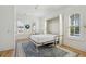 Bright bedroom featuring a wall bed pulled down to reveal a queen size bed, stylish rug, and windows at 3894 Sawyers Island Dr, Mount Pleasant, SC 29466