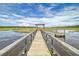 Picturesque wooden dock stretches across the marsh leading to tranquil waterfront views at 3894 Sawyers Island Dr, Mount Pleasant, SC 29466