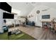 Entertainment room features a golf simulator, projector, TV, brick walls, beverage station, and hardwood flooring at 3894 Sawyers Island Dr, Mount Pleasant, SC 29466