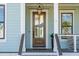 Elegant front door with glass panels, complemented by sidelights and exterior lighting at 3894 Sawyers Island Dr, Mount Pleasant, SC 29466