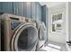 Modern laundry room with front load washer and dryer and custom cabinets at 3894 Sawyers Island Dr, Mount Pleasant, SC 29466