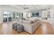 Open-concept living area with hardwood floors, large windows, and stylish furniture at 3894 Sawyers Island Dr, Mount Pleasant, SC 29466