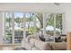 A luxurious living room provides a beautiful open air view to a furnished back porch and pool at 3894 Sawyers Island Dr, Mount Pleasant, SC 29466