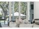 Relaxing living room with gray fireplace and a peaceful pool view outside of the large windows at 3894 Sawyers Island Dr, Mount Pleasant, SC 29466